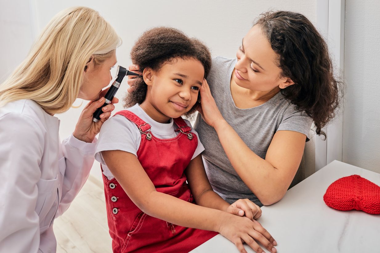 child being examined for hearing loss